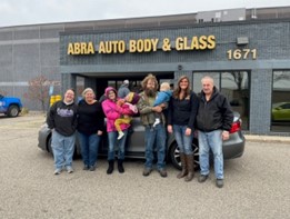 large-group-of-people-outside-body-shop